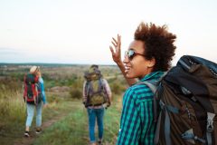 beautiful-woman-with-backpack-smiling-scaled